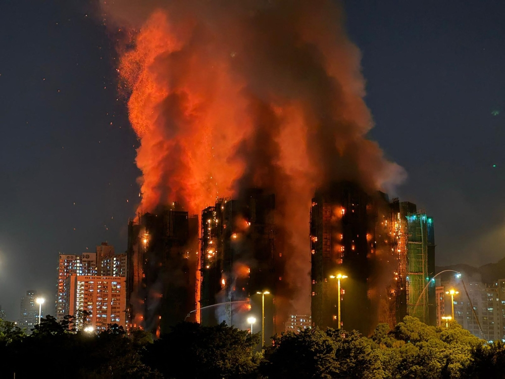 Hong Kong leader apologises for deadly blaze that killed 168 as housing minister resigns